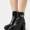 Best Michael Michael Kors Parker Lug Bootie High Heeled Ankle Boots Black/Brown